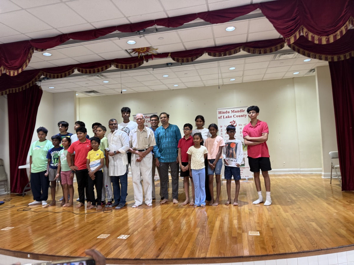 More than twenty young players and their mentors lined up together in a hall after the tournament.