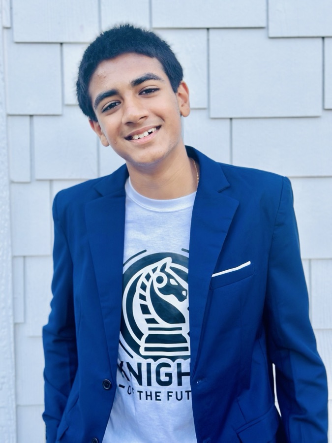 Kabir Gulati, wearing a navy blazer over a Knights of the Future t-shirt.